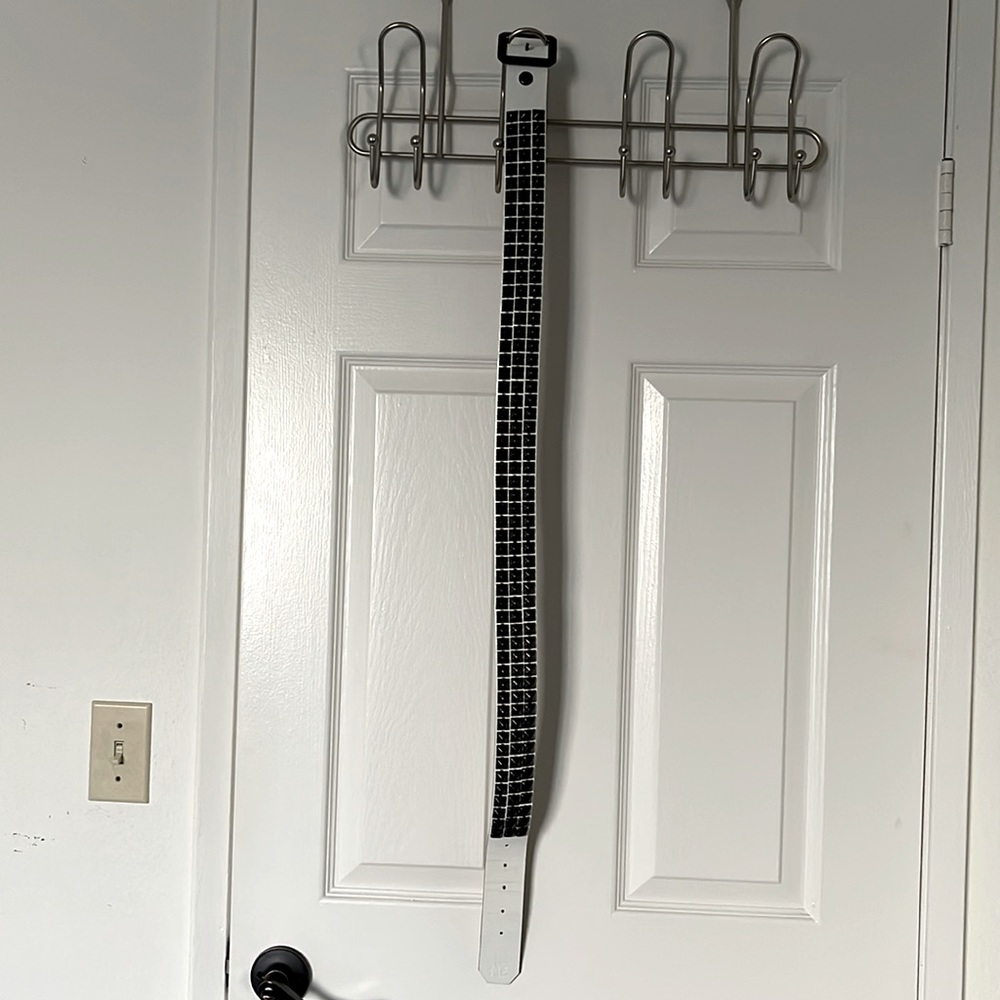 White and black large studded belt. Real leather